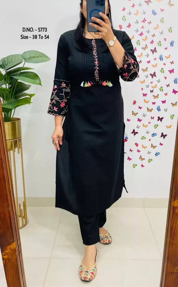 Girl wearing a black Elegant Cotton Slub Kurti Pant Cord Set – Hand Aari Embroidery & Pintex Work from dailyimprovise, and posing for photo