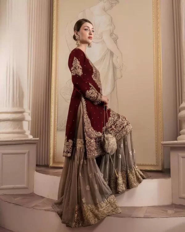 Girl wearing a red Elegant Georgette Kurti Sharara Set – Heavy Sequins Embroidery with Dupatta from dailyimprovise, and posing for photo