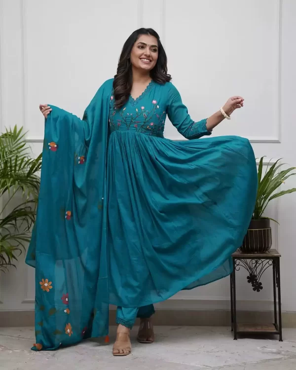 Girl wearing a Elegant Pure Teal Cotton Embroidered Suit Set – 3-Piece Ethnic Wear from dailyimprovise, and having a smile on her face