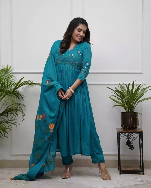 Girl wearing a Elegant Pure Teal Cotton Embroidered Suit Set – 3-Piece Ethnic Wear from dailyimprovise, and posing for photo