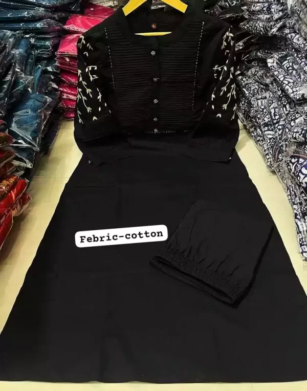 Black embroidered rayon pant set displayed flat