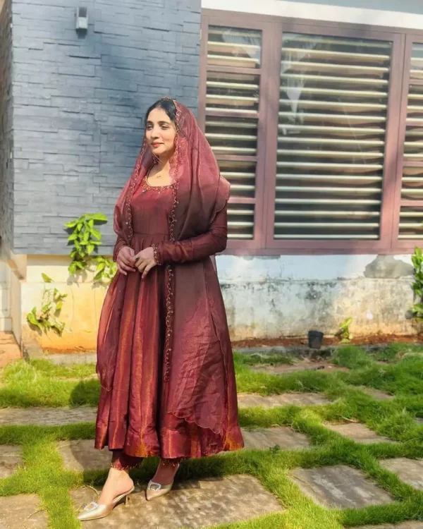 Girl wearing maroon Designer Jimmi Chhoo Anarkali Set with Sequins Embroidery & Dupatta from dailyimprovise and having simle on face